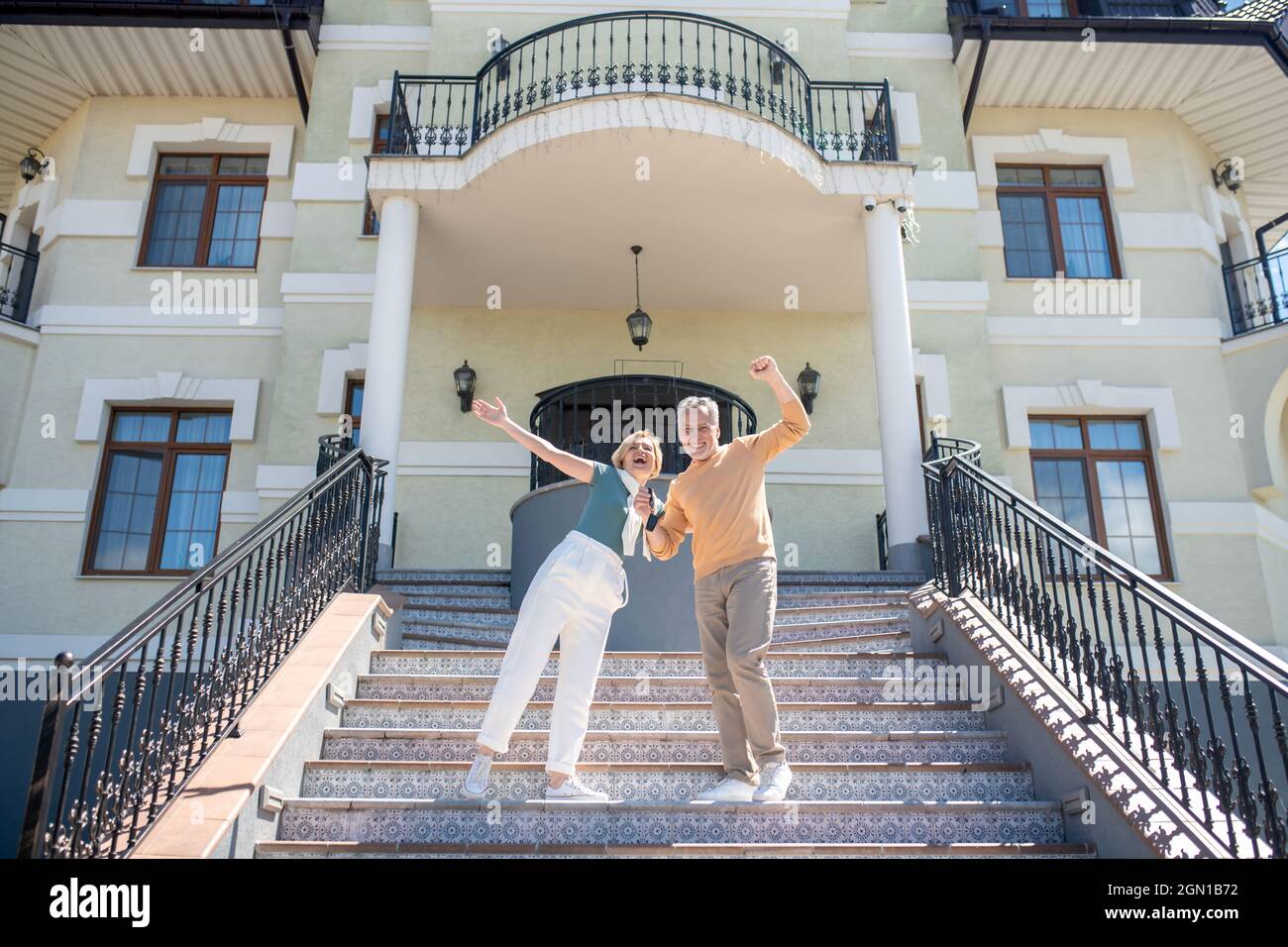 Man and his wife rejoicing at their new expensive purchase Stock Photo