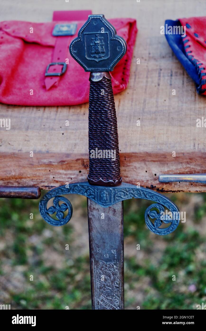 reproduction of medieval sword on display during a historical re enactment in costume Stock Photo