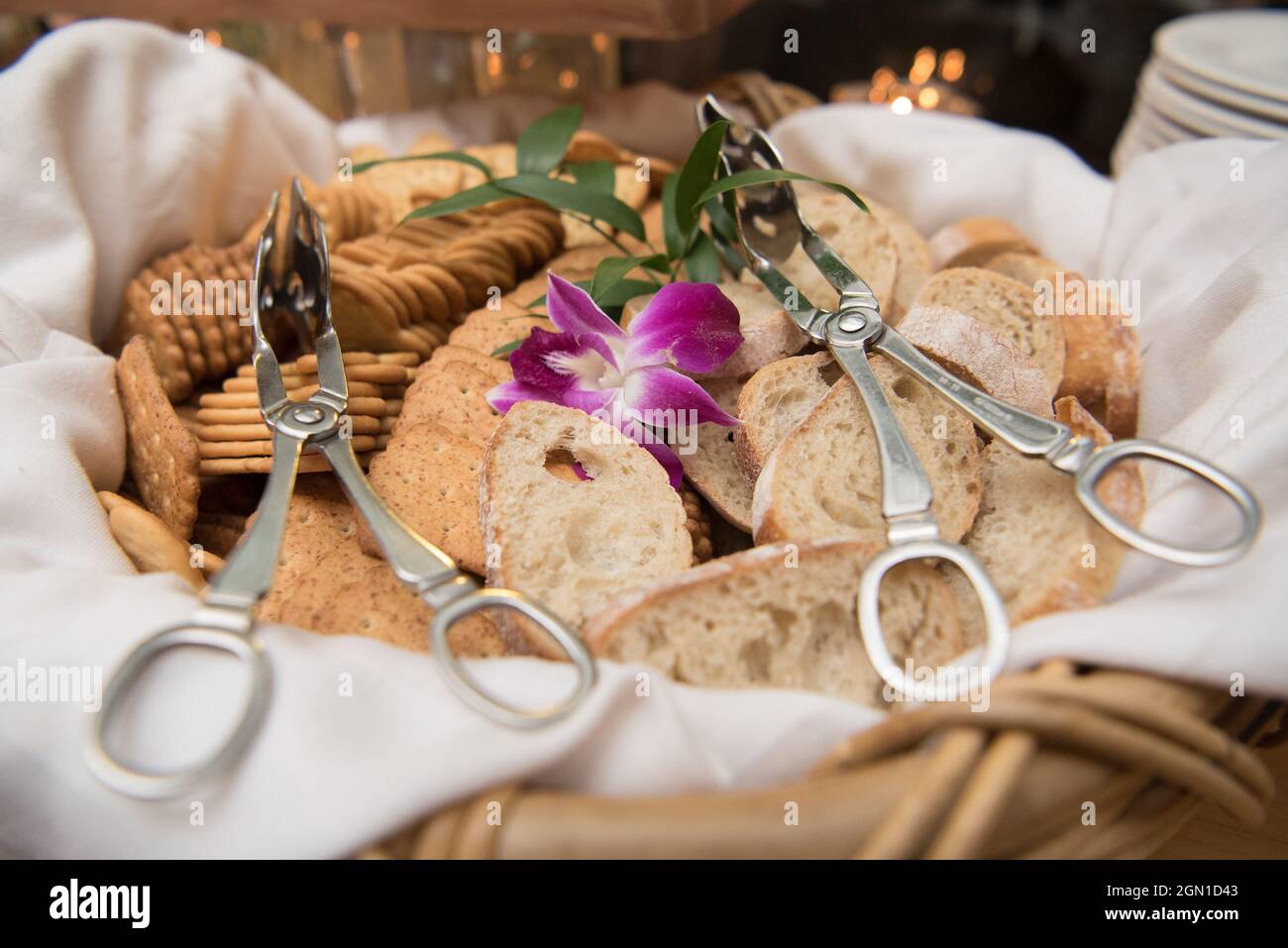 Bread and cracker basket with serving tongs Stock Photo Alamy