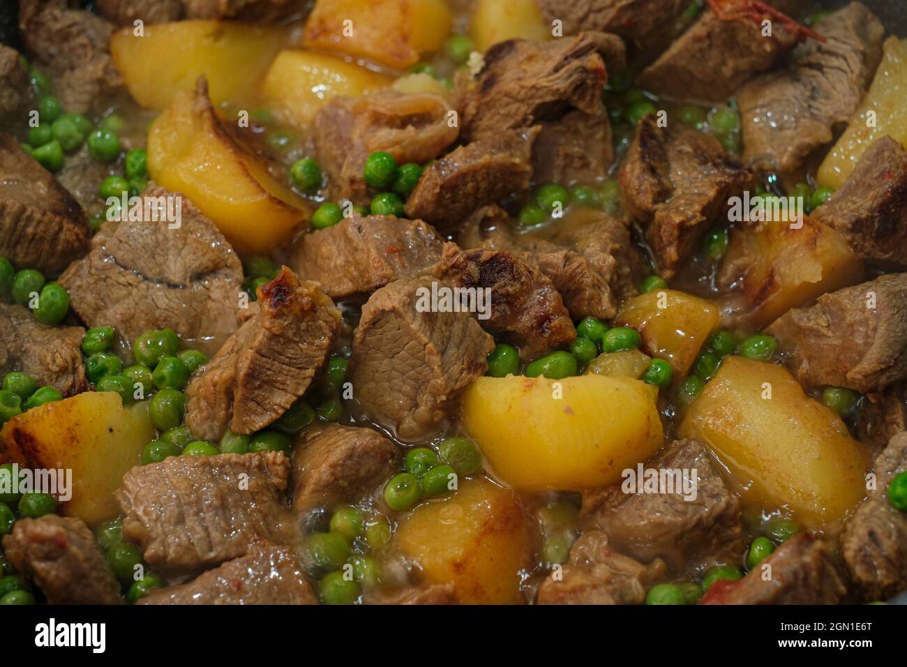 Tasty slow cooked beef meat stew with potatoes close up,homemade food background Stock Photo