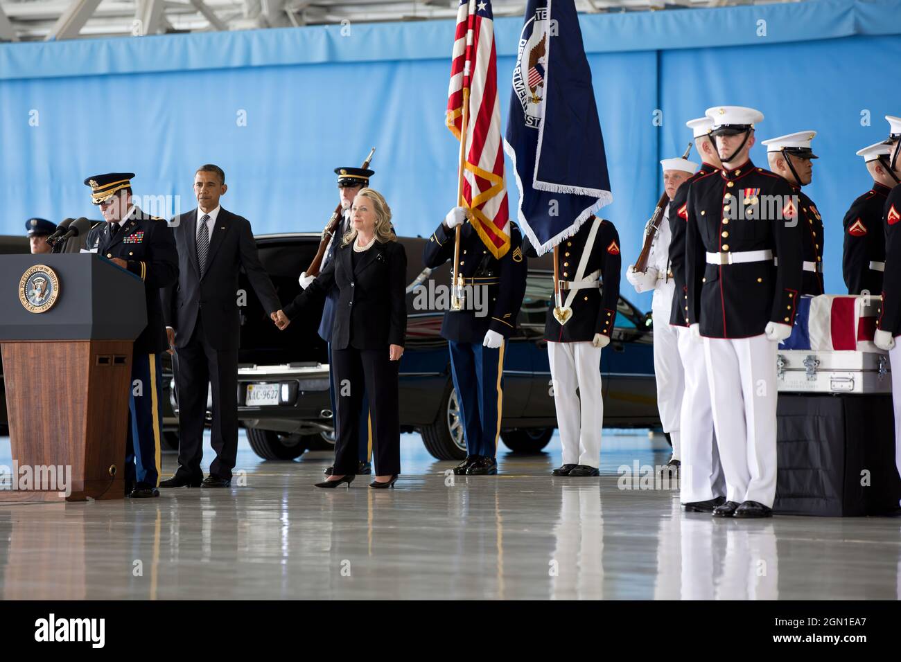 President Barack Obama stands with Secretary of State Hillary Rodham Clinton during the transfer of remains ceremony at Joint Base Andrews, Md., Sept. 14, 2012, marking the return to the United States of the remains of the four Americans killed in Benghazi, Libya. (Official White House Photo by Pete Souza) President Barack Obama stands with Secretary of State Hillary Rodham Clinton during the transfer of remains ceremony at Joint Base Andrews, Md., Sept. 14, 2012, marking the return to the United States of the remains of J. Christopher Stevens, U.S. Ambassador to Libya; Sean Smith, Information Stock Photo
