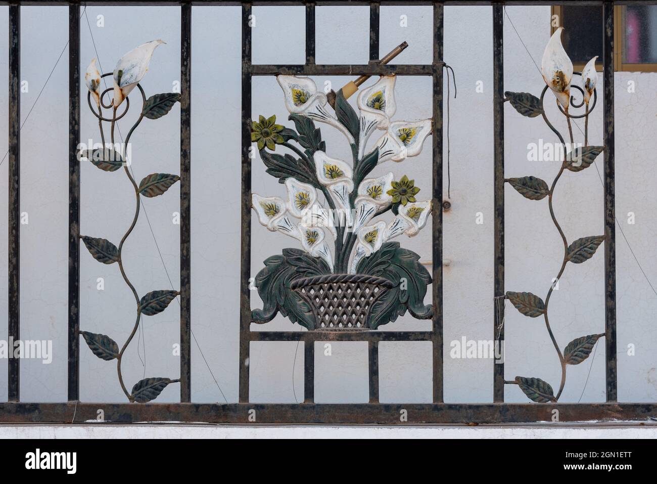 A decorative ironworks gate in front of a home in Mexico. Stock Photo