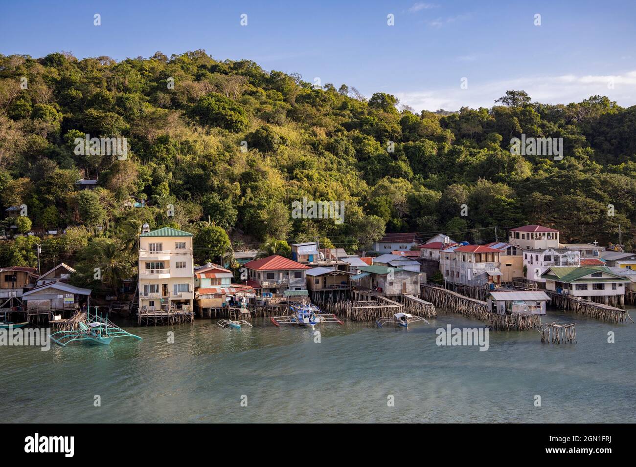 Houses on stilts and traditional Filipino Banca outrigger canoes