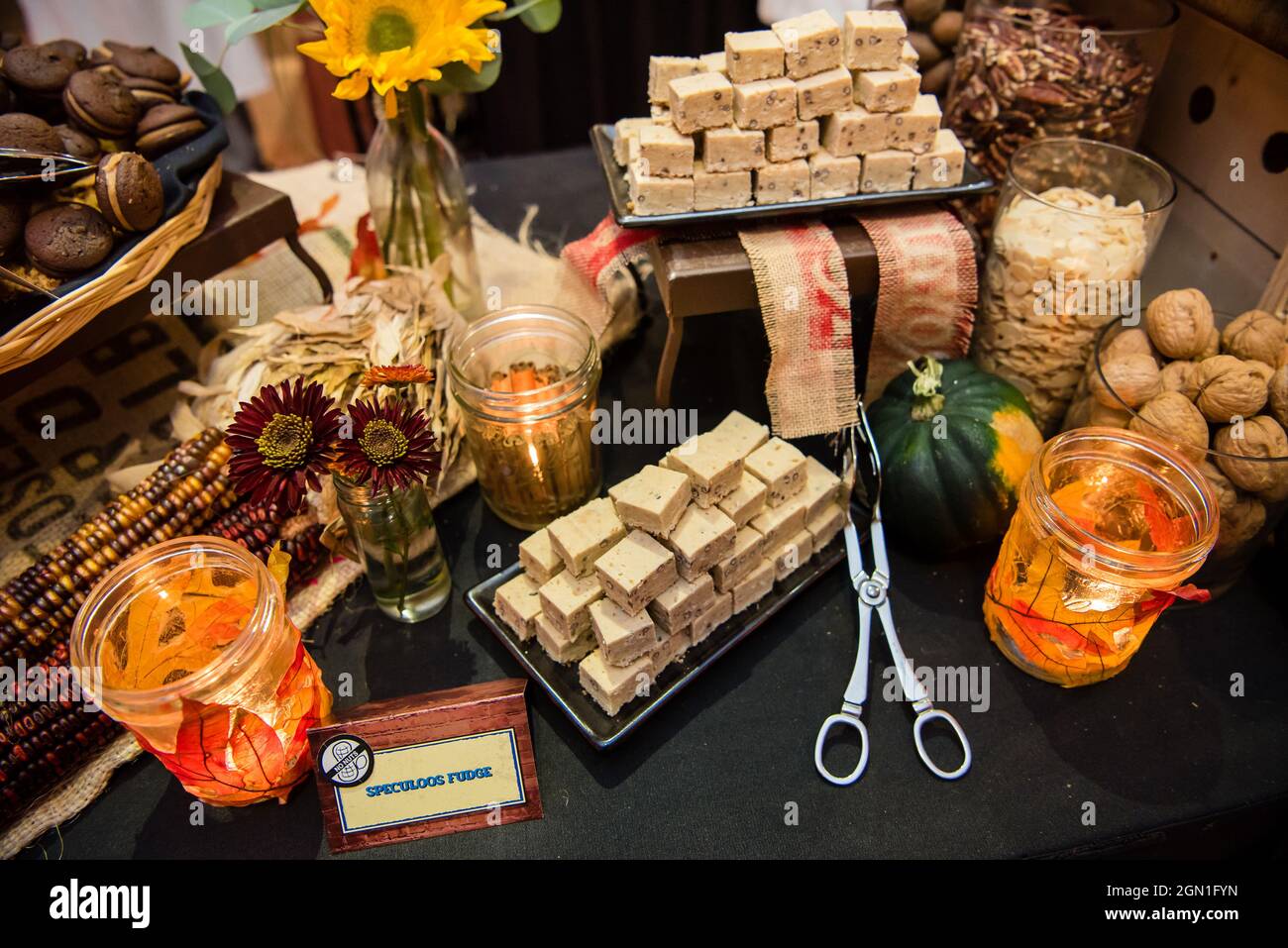 Autumn food spread with fudge flowers and leaf decor. Stock Photo