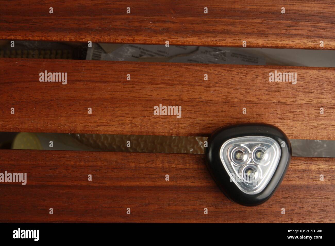 Closeup shot of a triangular black flashlight led light on a ...