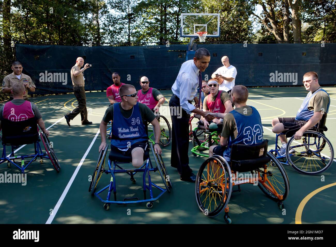 President Barack Obama greets players during a Wounded Warrior basketball game on the South Lawn basketball court at the White House, July 26, 2011. (Official White House Photo by Pete Souza) This official White House photograph is being made available only for publication by news organizations and/or for personal use printing by the subject(s) of the photograph. The photograph may not be manipulated in any way and may not be used in commercial or political materials, advertisements, emails, products, promotions that in any way suggests approval or endorsement of the President, the First Famil Stock Photo