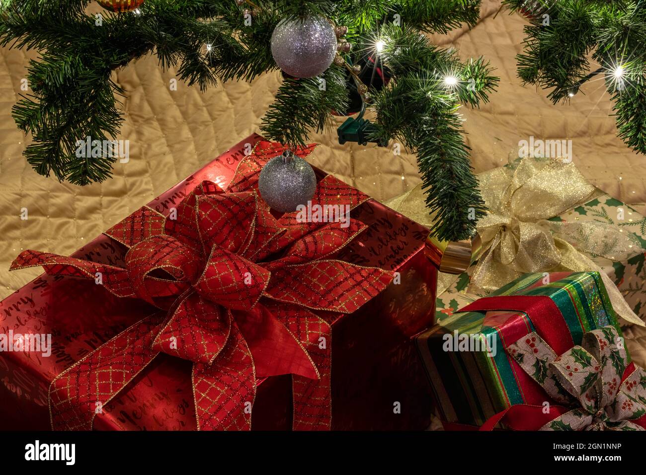 Beautiful packed Christmas gifts under the Christmas tree at home. Holiday concept. Stock Photo