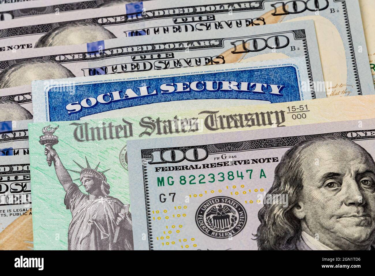 Social Security card, treasury check and 100 dollar bills. Concept of social security benefits payment, retirement and federal government benefits Stock Photo