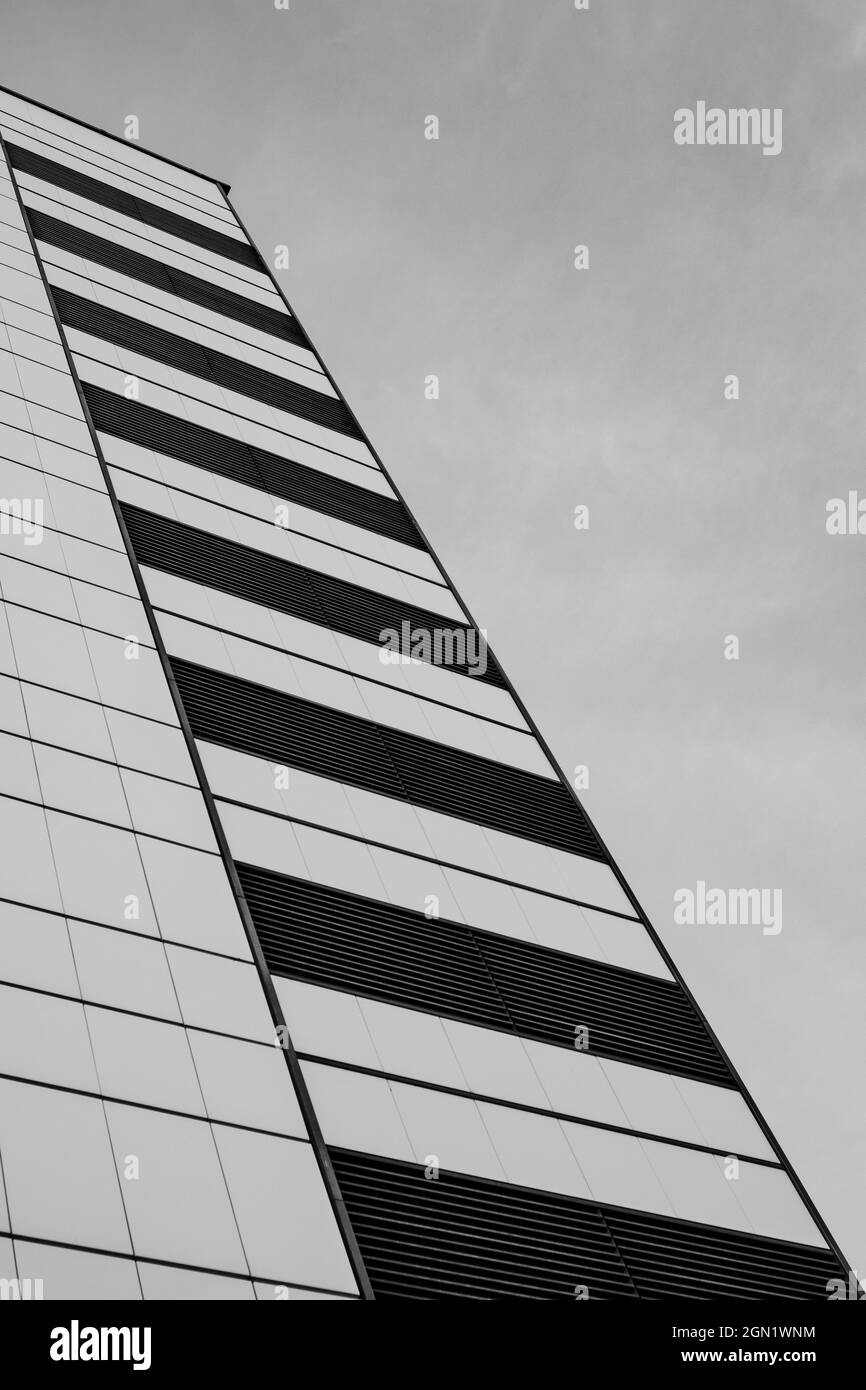 Vertical grayscale shot of a modern building during daylight Stock ...