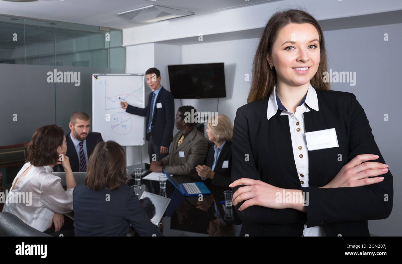business woman in meeting room with working group behind Stock Photo ...