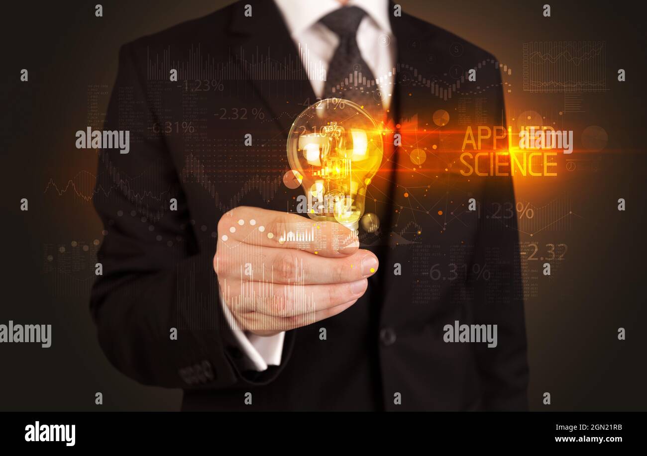 Businessman holding a lightbulb concept Stock Photo - Alamy