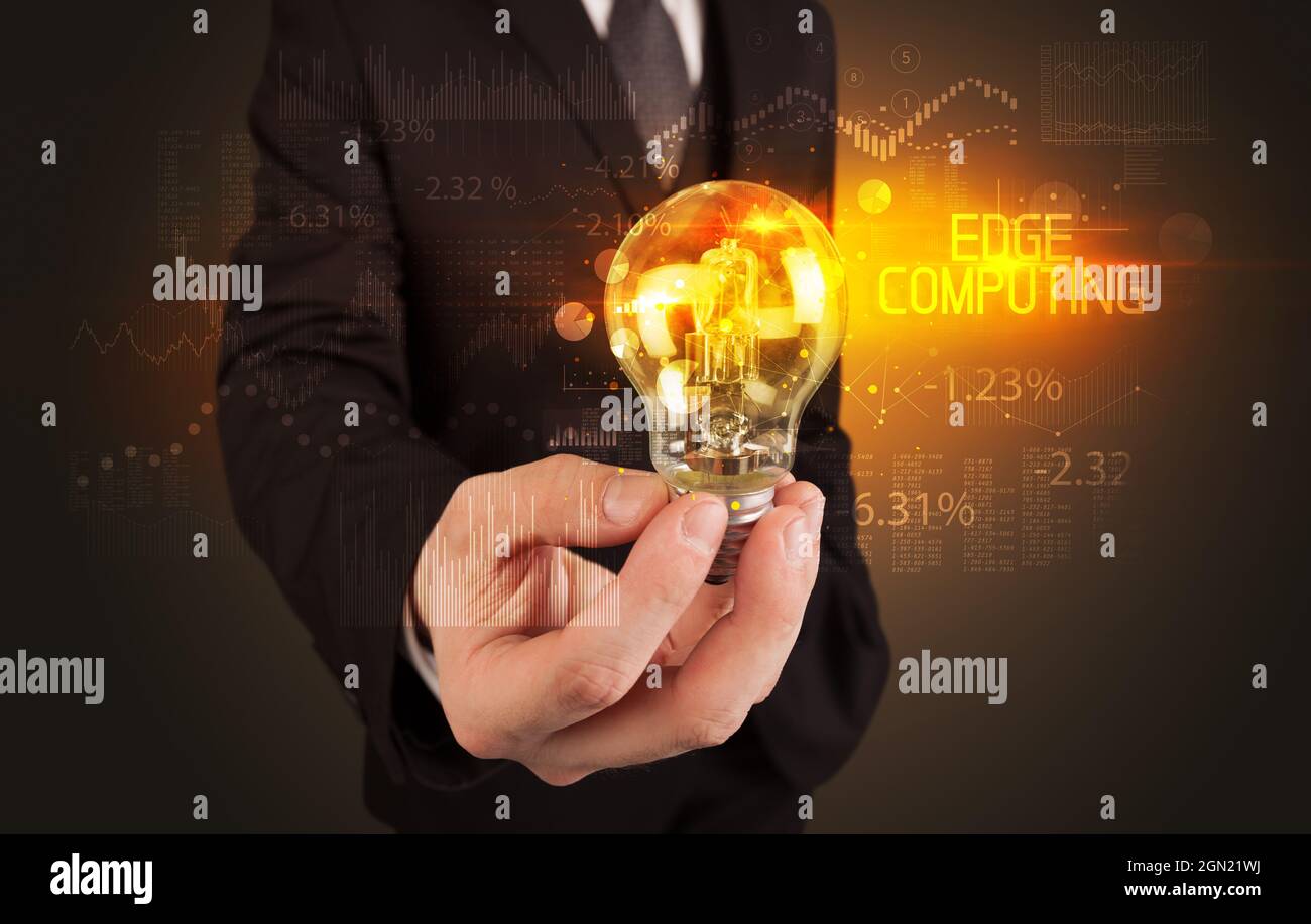 Businessman holding a lightbulb concept Stock Photo - Alamy