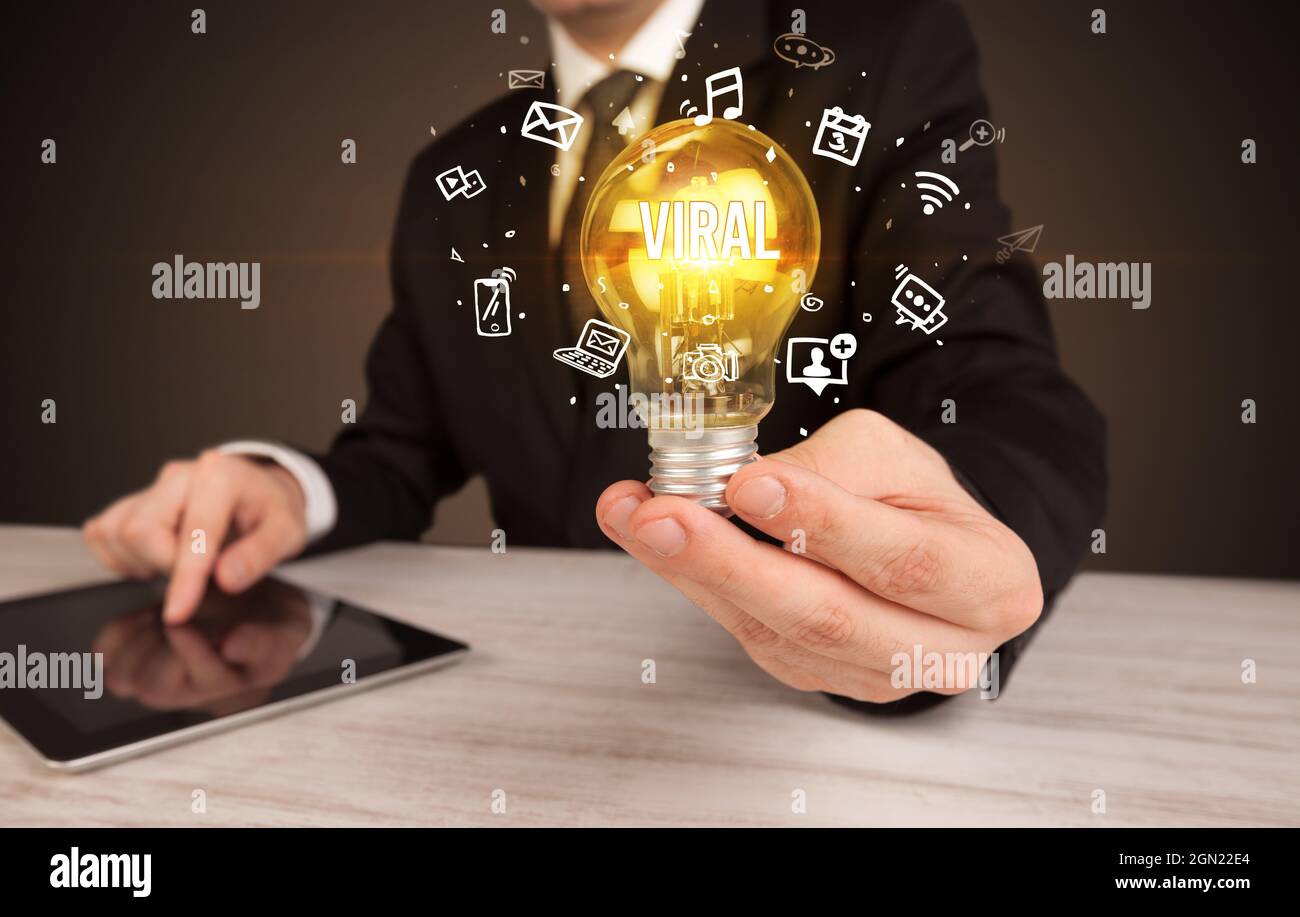 Businessman holding a light bulb, social media concept Stock Photo - Alamy