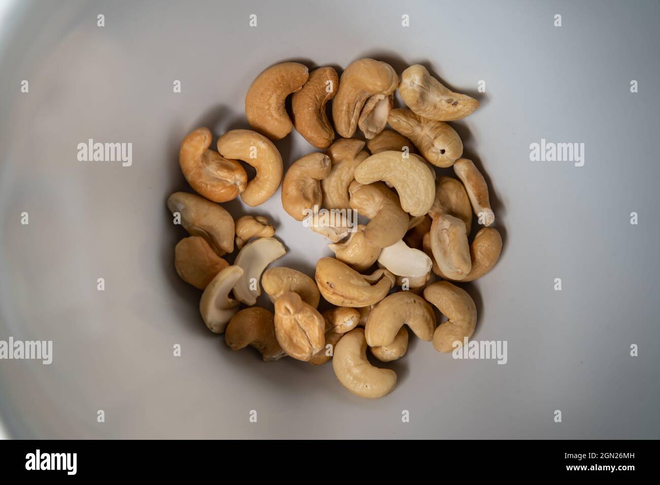 Roasted cashew nut in a white bowl Stock Photo