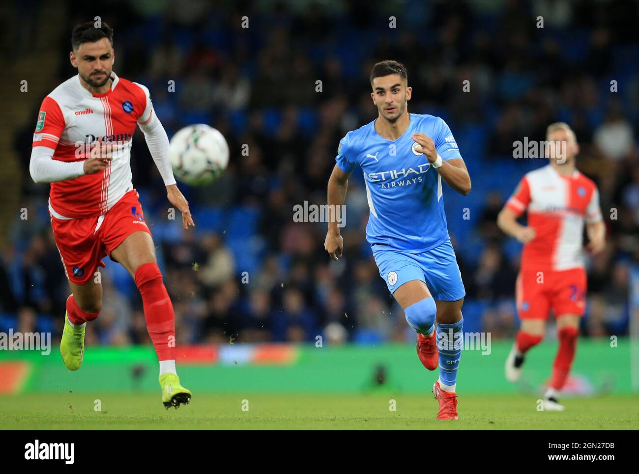 Etihad Stadium, Manchester, UK. 21st Sep, 2021. EFL Cup Football Manchester City versus Wycombe Wanderers; Ferran Torres of Manchester City and Ryan Tafazolli of Wycombe Wanderers race after the ball Credit: Action Plus Sports/Alamy Live News Stock Photo