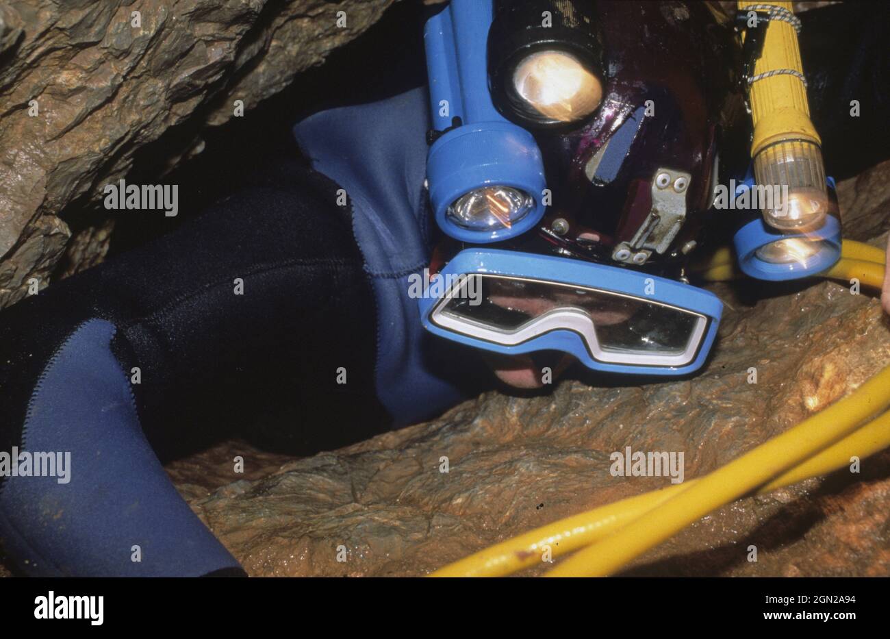 Diver exiting McCavity Cave. The tight passage into and out of the flooded McCavity is via this tight restriction called the Birth Canal. Wellington C Stock Photo