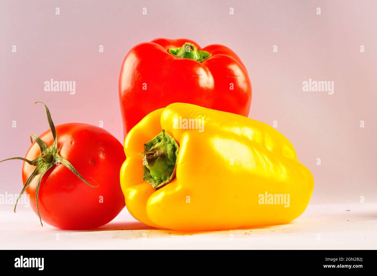 Yellow paper and tomato on the table Stock Photo
