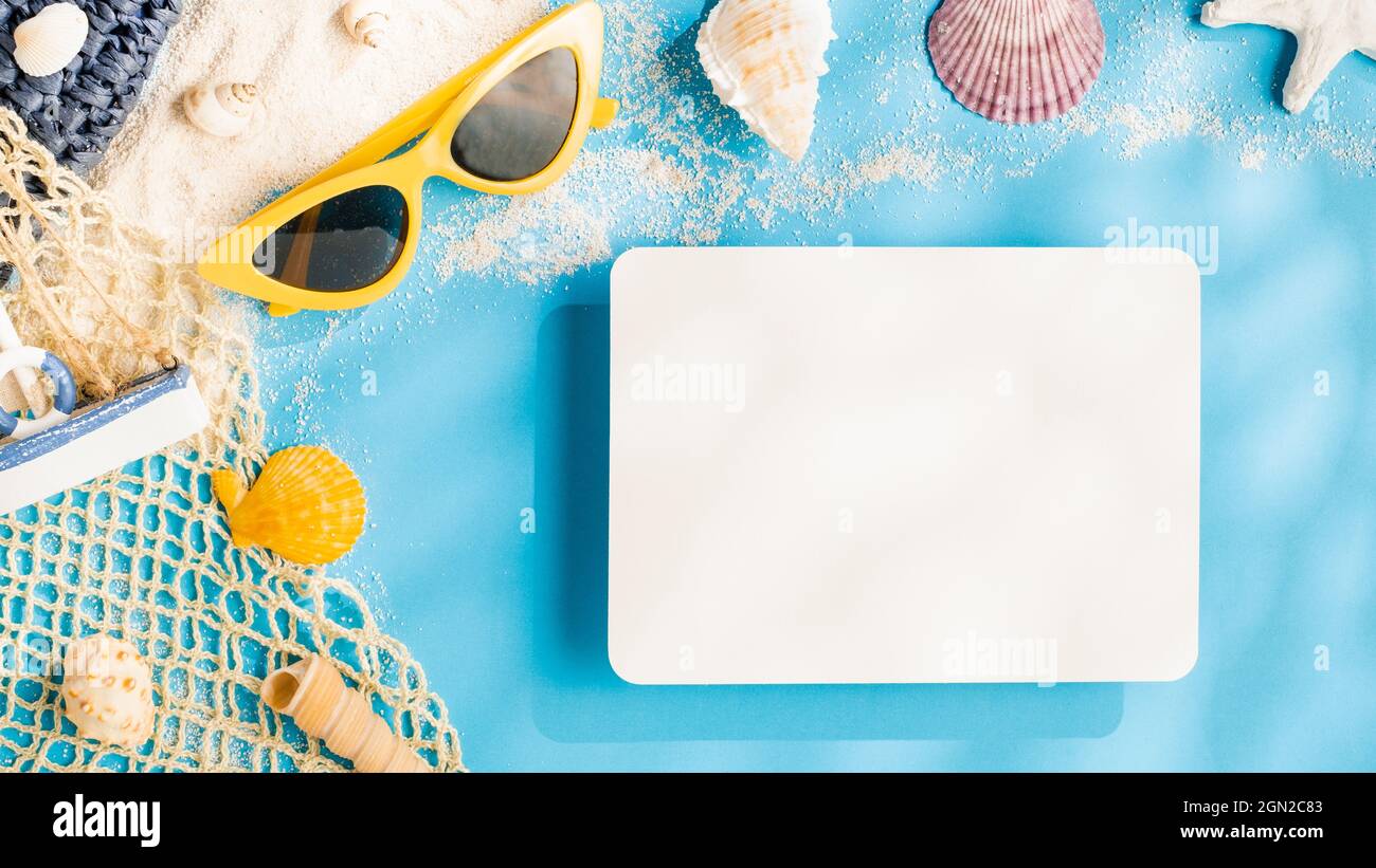 summer sunlight concept.blank paper card on beach accessory on blue sea background Stock Photo