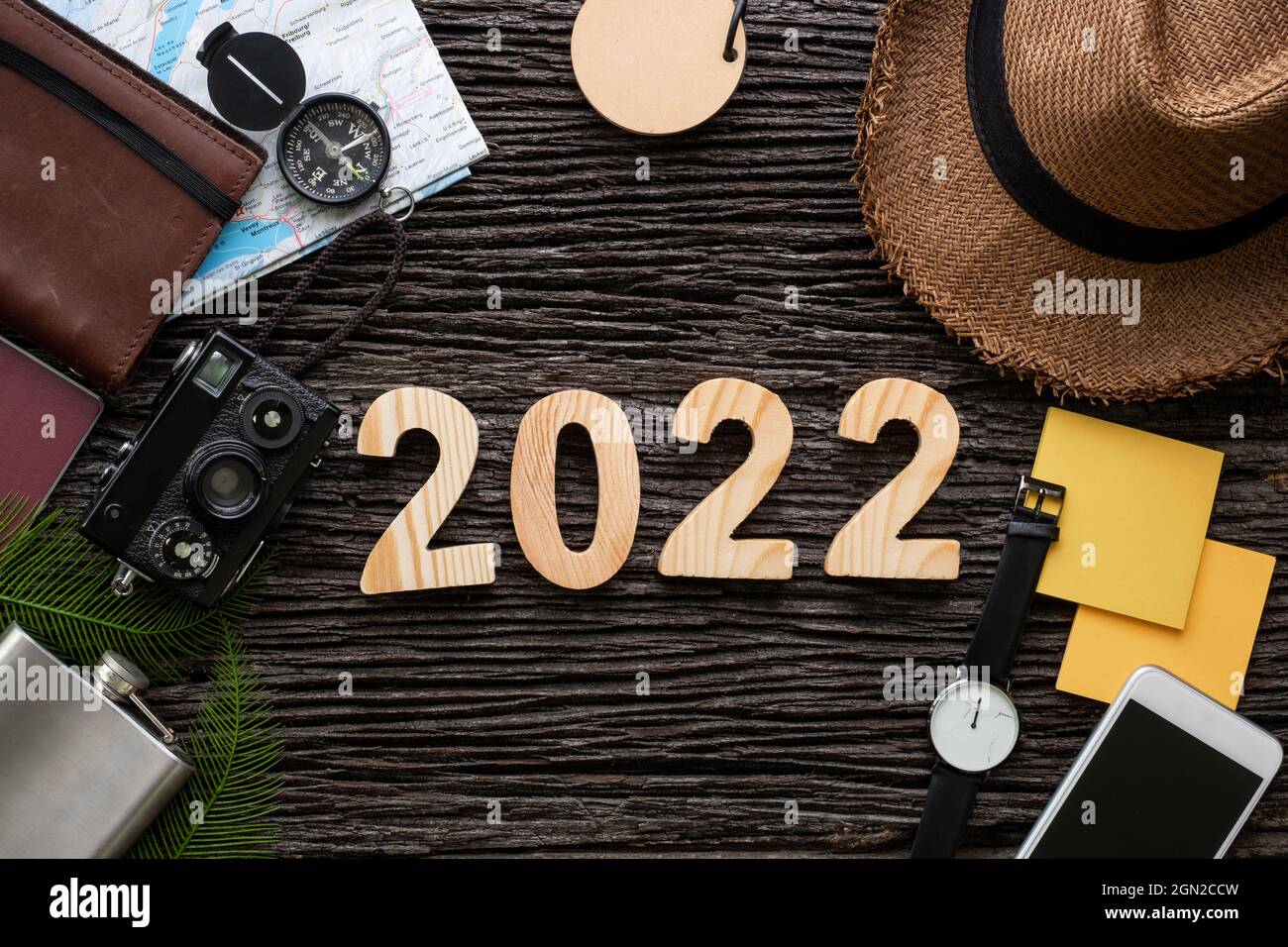 top view 2022 happy new year number on wood table with adventure accessory item,holiday vacation planning Stock Photo