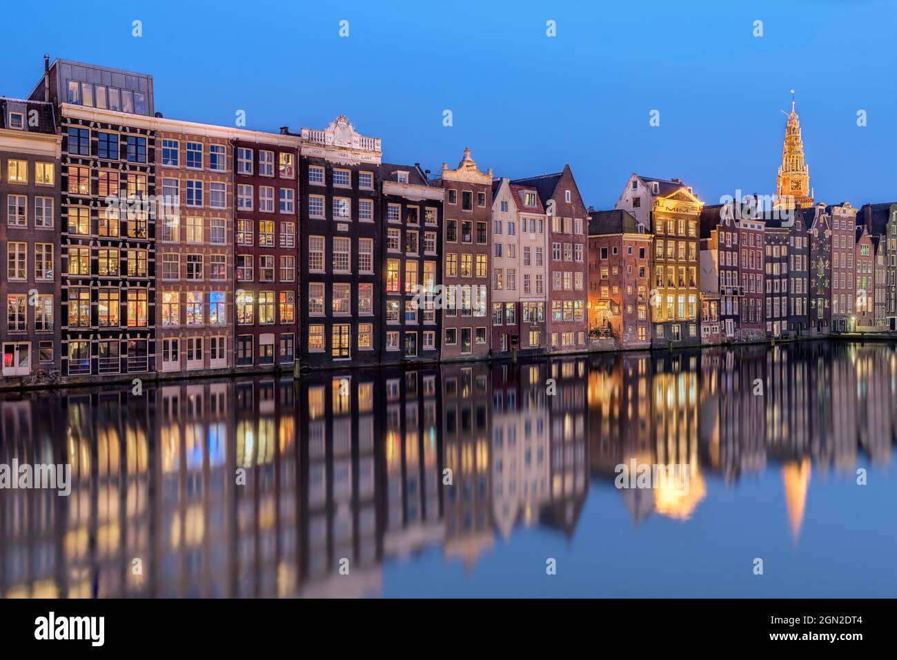 NETHERLANDS, AMSTERDAM, TYPICAL HOUSES AND CHURCH DURING BLUE HOUR Stock Photo