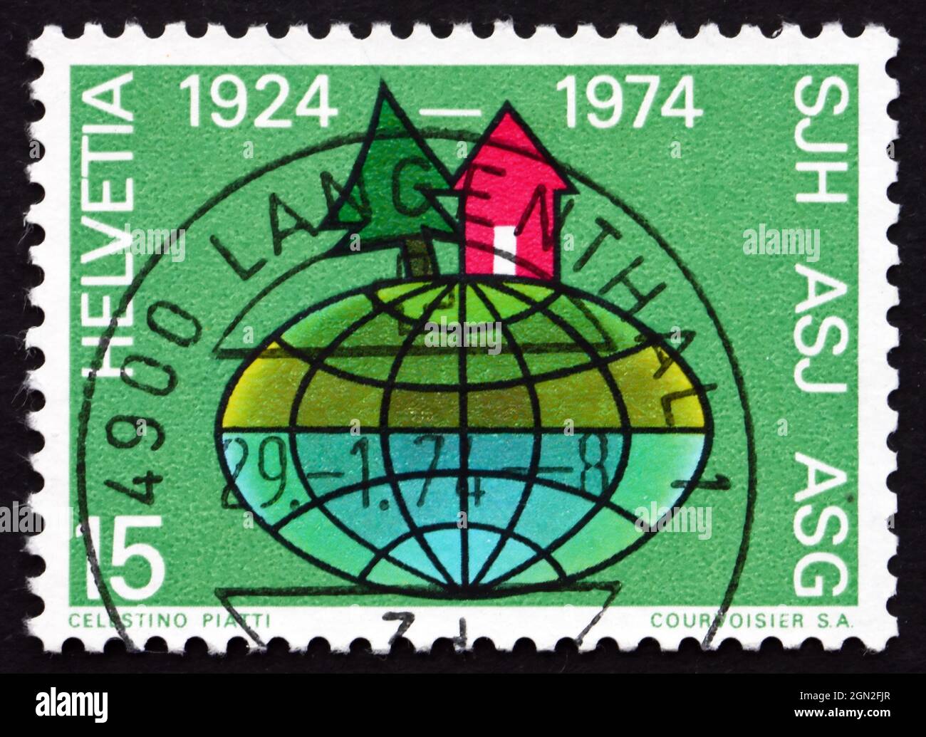 SWITZERLAND - CIRCA 1974: a stamp printed in the Switzerland shows Pine and Cabin on Globe, 50th Anniversary of Swiss Youth Hostels, circa 1974 Stock Photo