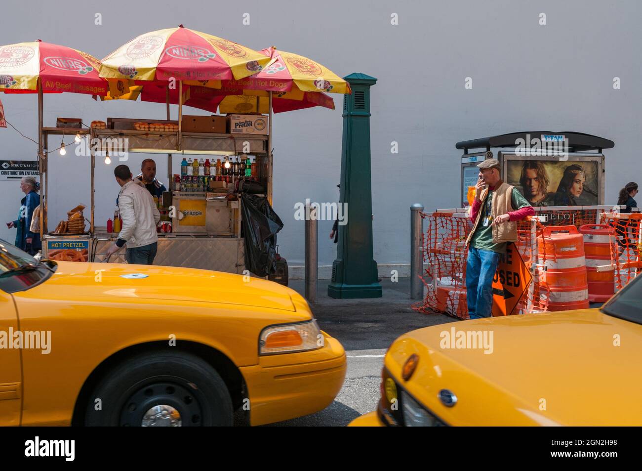USA, NEW YORK, SCENE OF LIFE ON A NEW YORK STREET WITH YELLOW TAXIS IN THE FOREGROUND Stock Photo