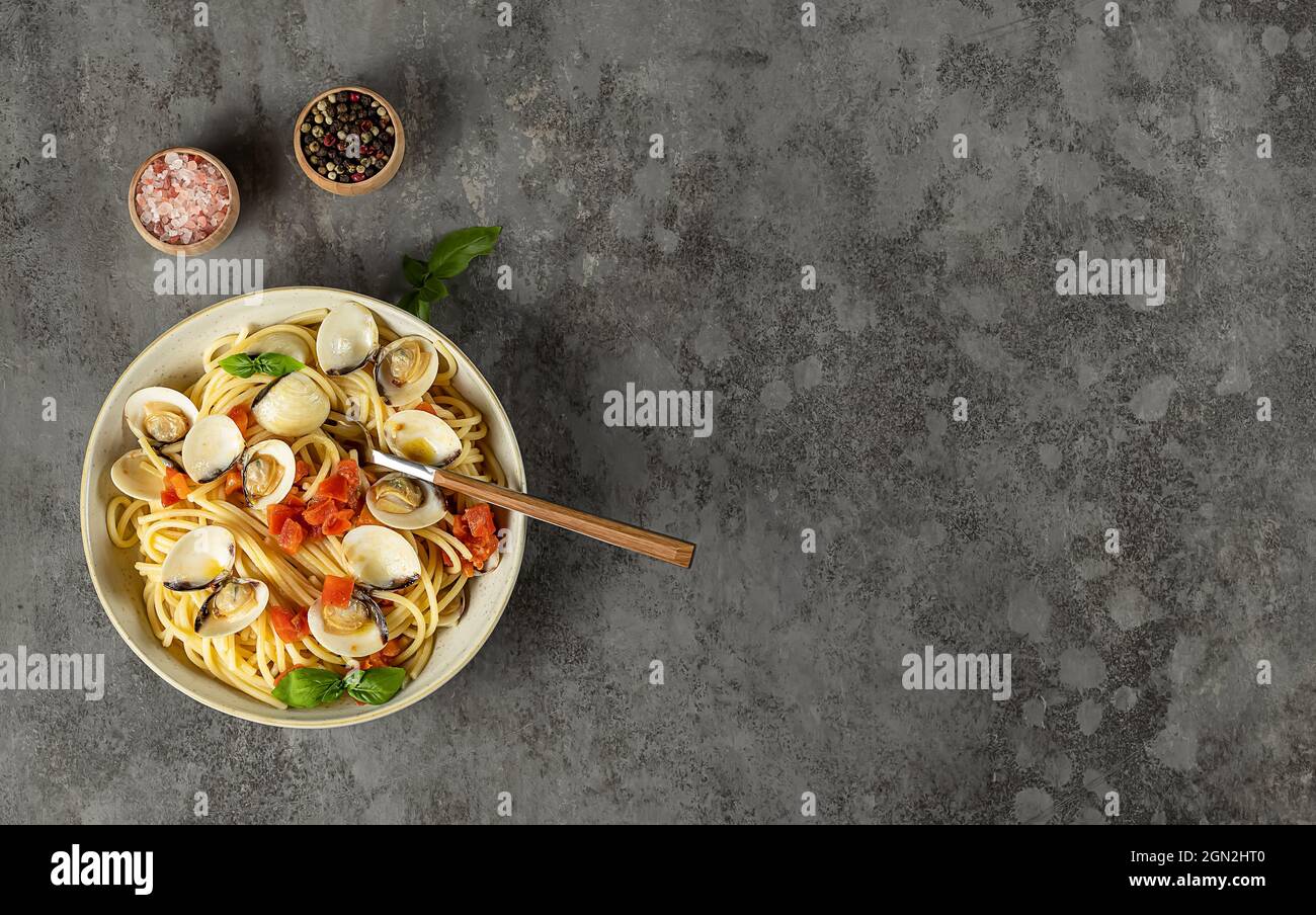 Traditional Italian seafood pasta with clams. Spaghetti alle Vongole. banner, top view, copy space. Stock Photo