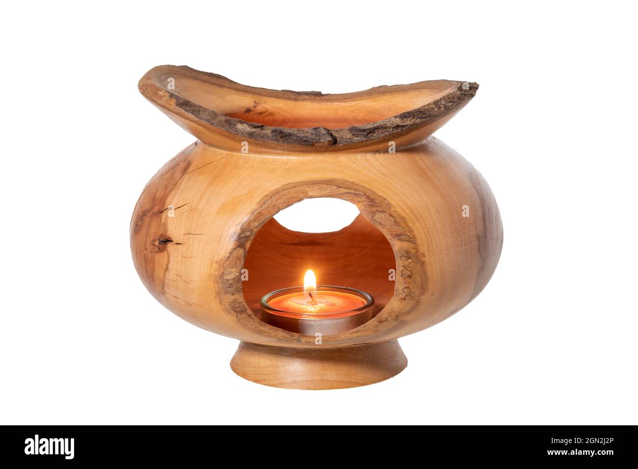Openwork turned decorative object with a candle in a glass insert, isolated on white Stock Photo
