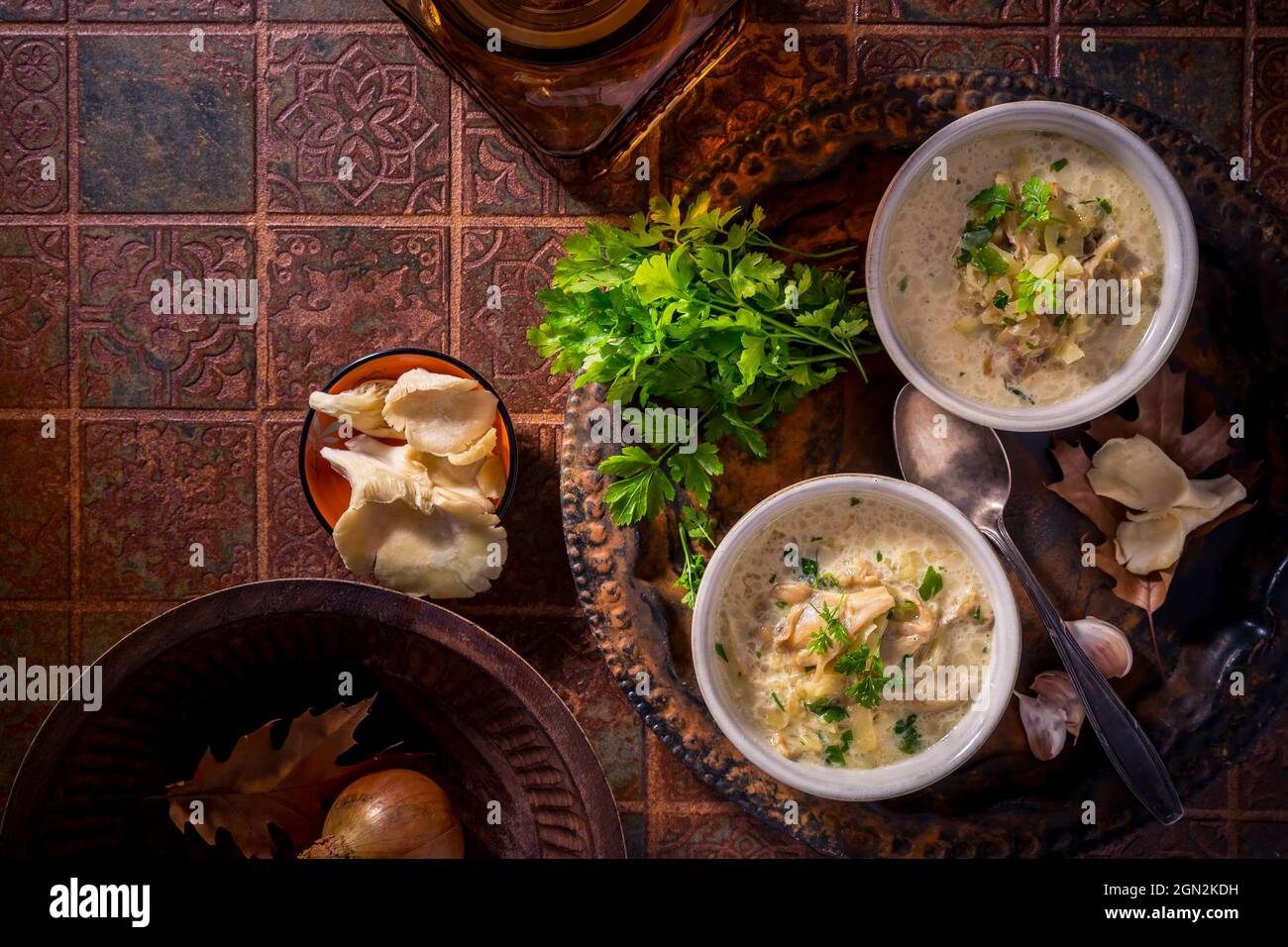 Vegan cabbage soup with oyster mushrooms with vegetables  on old kitchen table Stock Photo