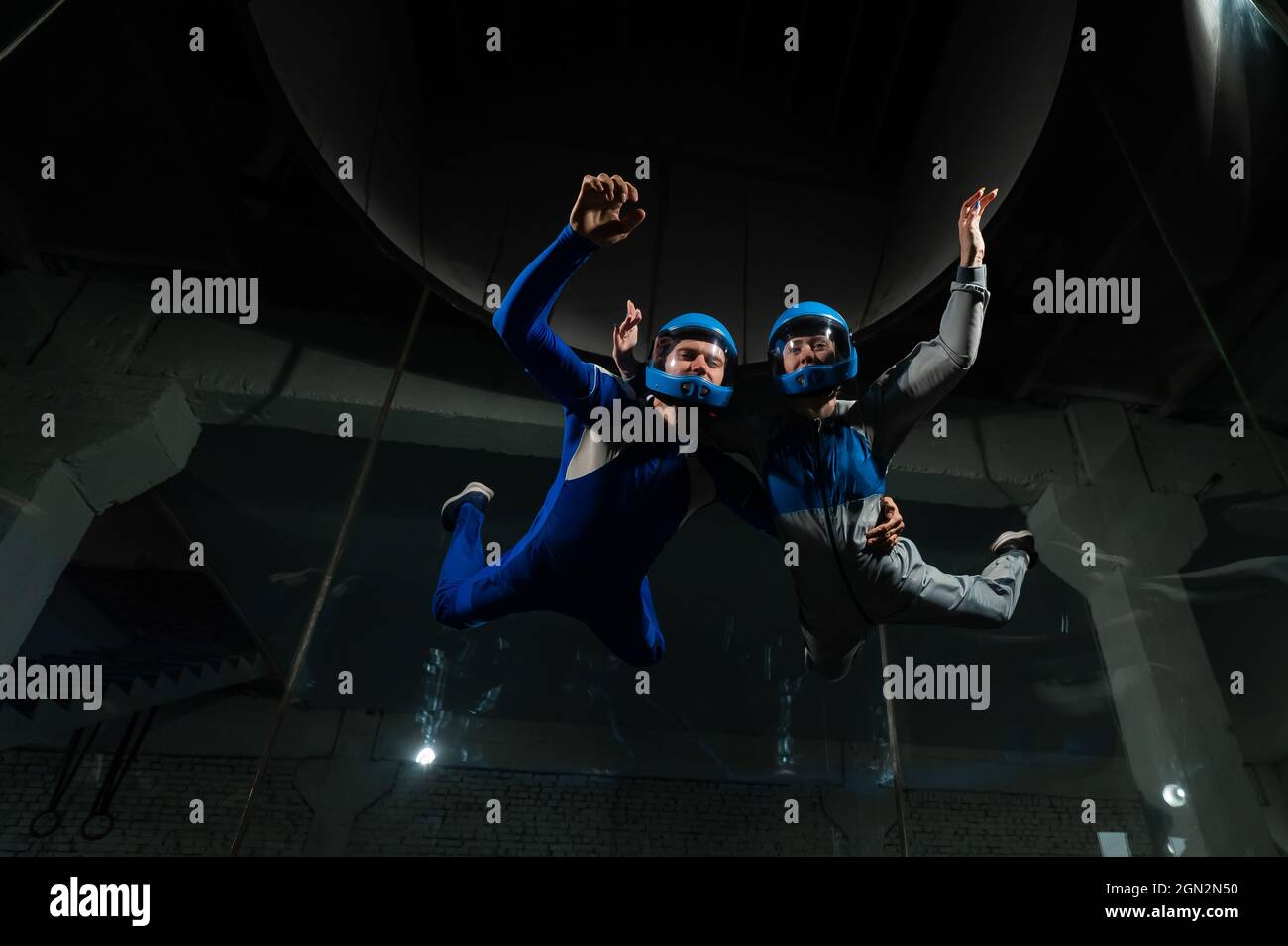 A man and a woman enjoy flying together in a wind tunnel. Free fall ...