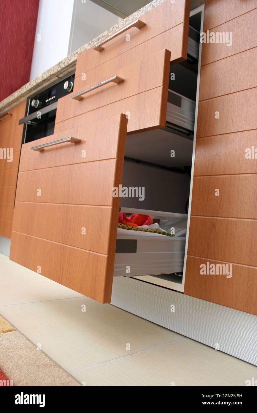 Modern and wooden kitchen drawers. Sliding kitchen drawers Stock Photo