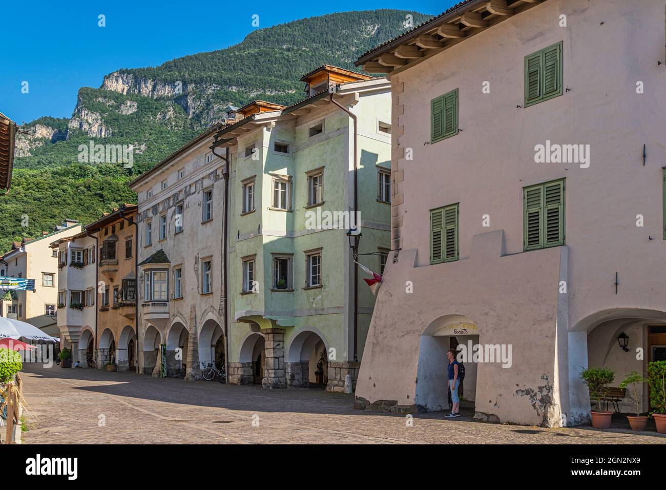 Characteristic houses of the ancient medieval center of Egna. The lowered arcades and the colored facades are a characteristic of this village. Stock Photo