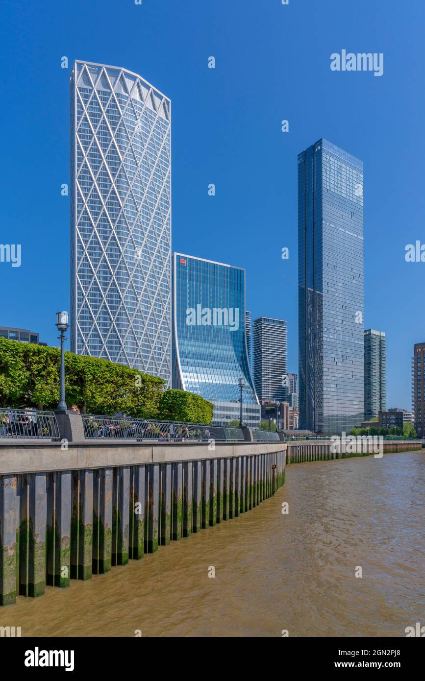 View of Canary Wharf tall buildings and alfresco eating from the Thames Path, London, England, United Kingdom, Europe Stock Photo