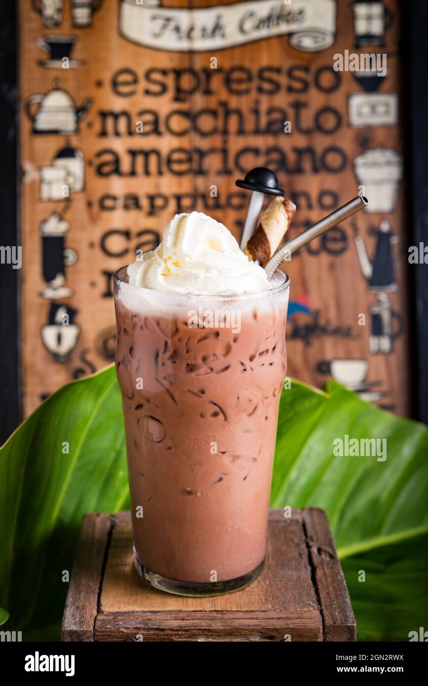 iced coffee drink with coffee menu board as background Stock Photo