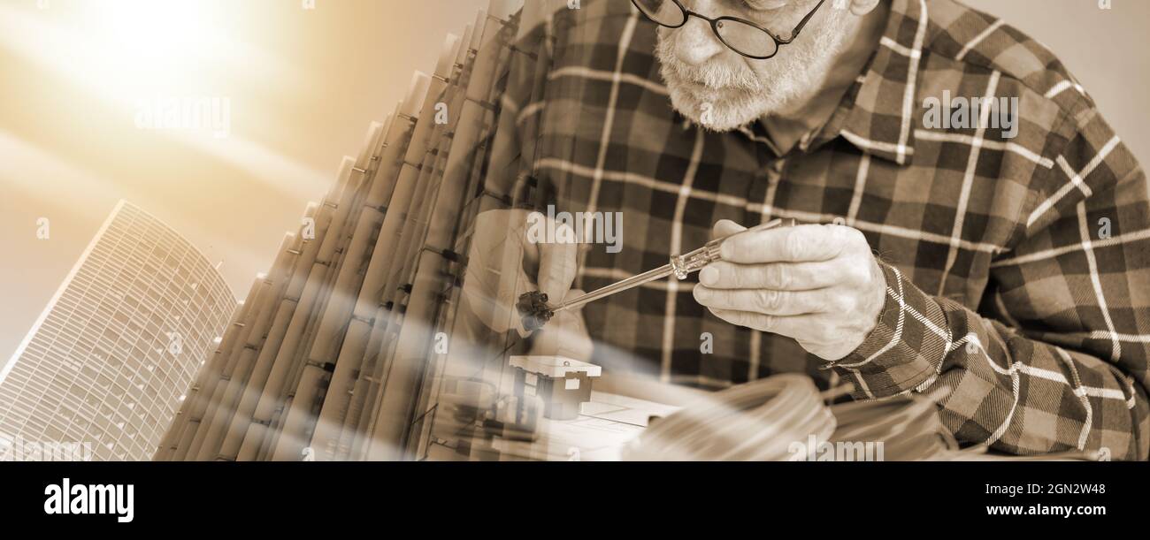 Senior electrician connecting wires in terminal block; multiple exposure Stock Photo