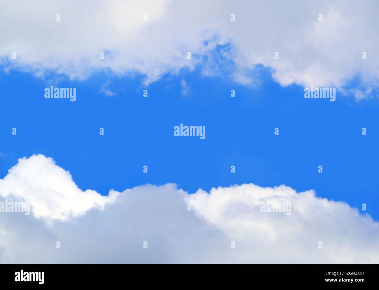Vivid Blue Sunny Sky between White Clouds with Copy Space Stock Photo