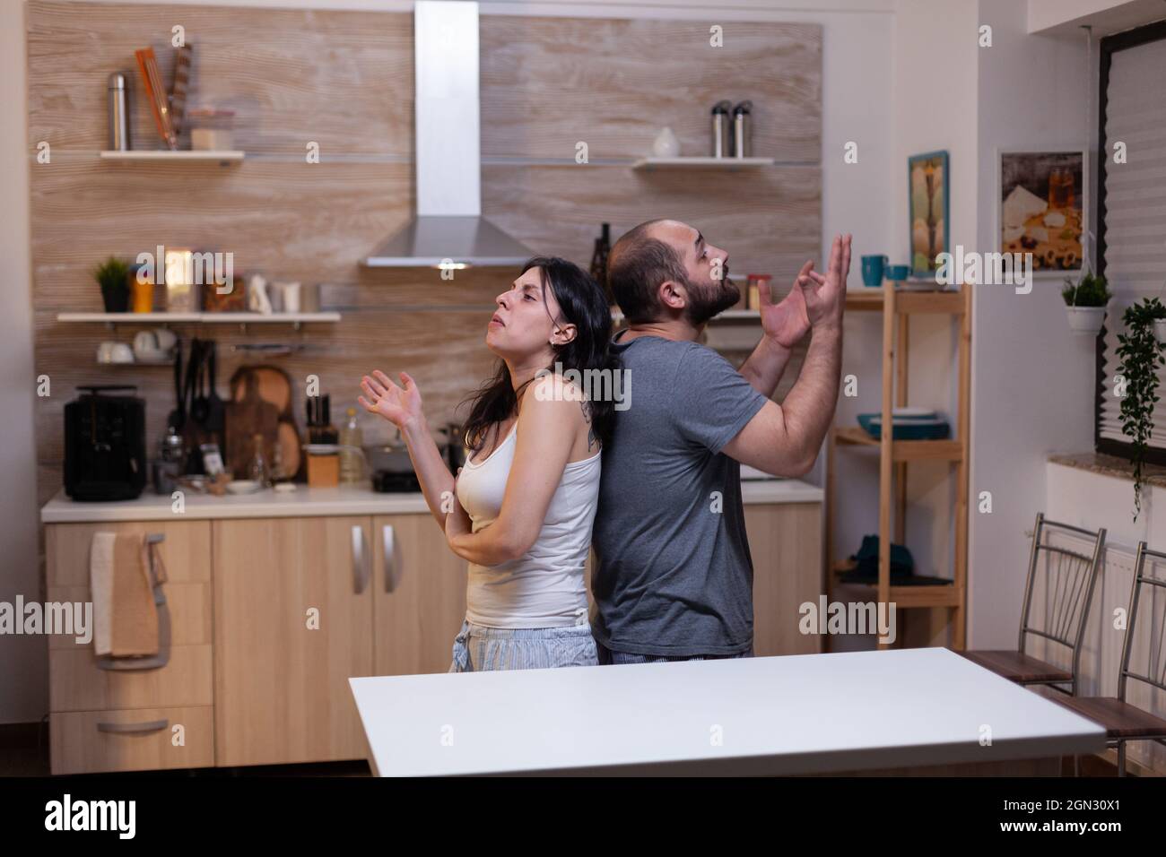 Caucasian couple having marriage problems and fighting at home. Angry man and irritated woman in relationship arguing about jealousy feeling unhappy and frustrated about scandal Stock Photo
