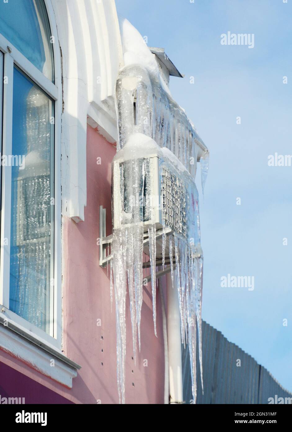Air conditioner compressor in ice. Frozen house air conditioning with ...