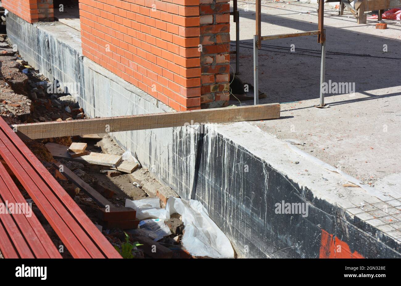 Foundation waterproofing. House foundation wall waterproof with bitumen  spray Stock Photo - Alamy