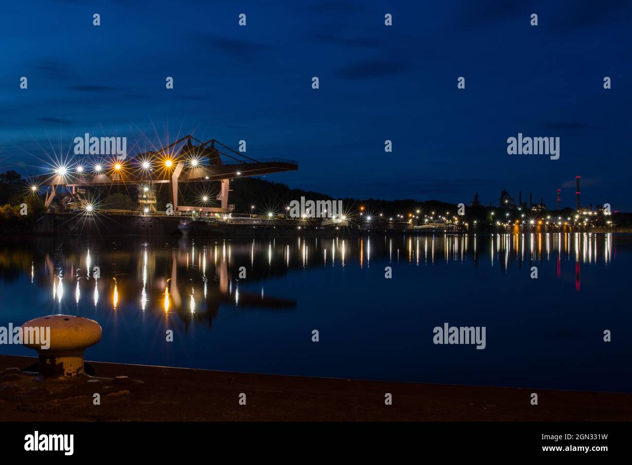Industrial harbor at night with a view of a steel mill called Dillinger Hütte in Dillingen Saar, Germany Stock Photo