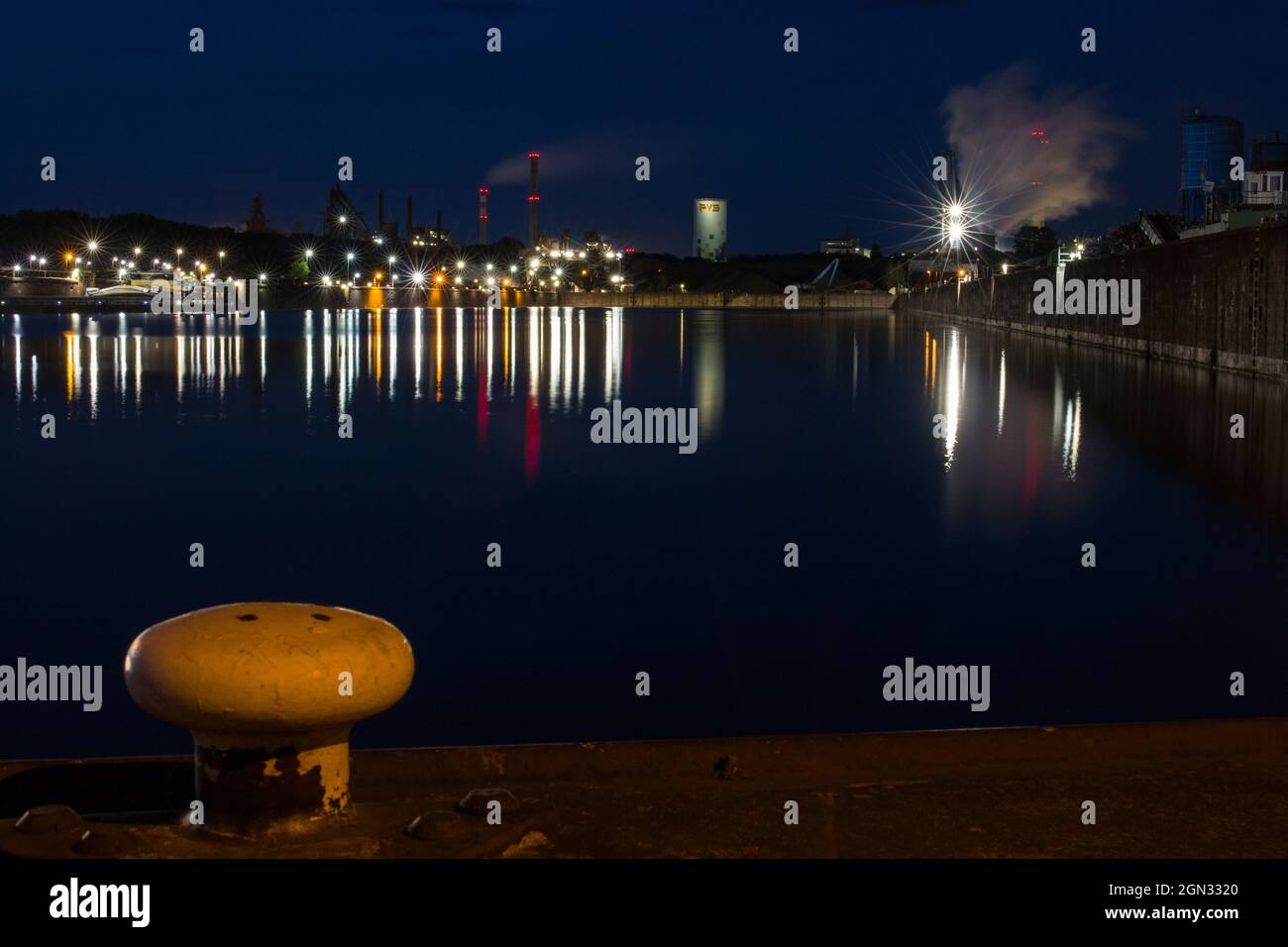 Industrial harbor at night with a view of a steel mill called Dillinger Hütte in Dillingen Saar, Germany Stock Photo