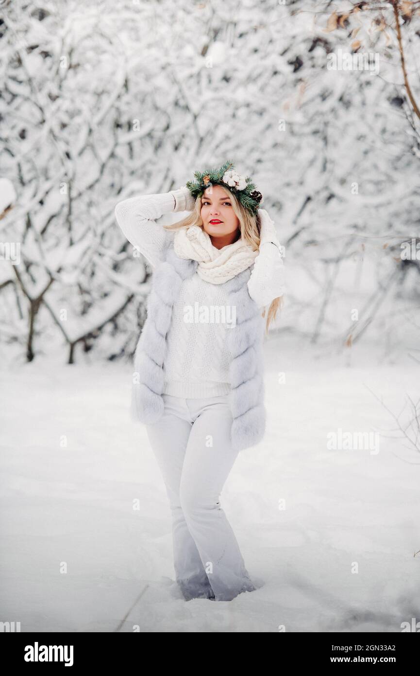 PPortrait of a woman in white clothes in a cold winter forest. Girl with a  wreath on her head in a snow-covered winter forest Stock Photo - Alamy