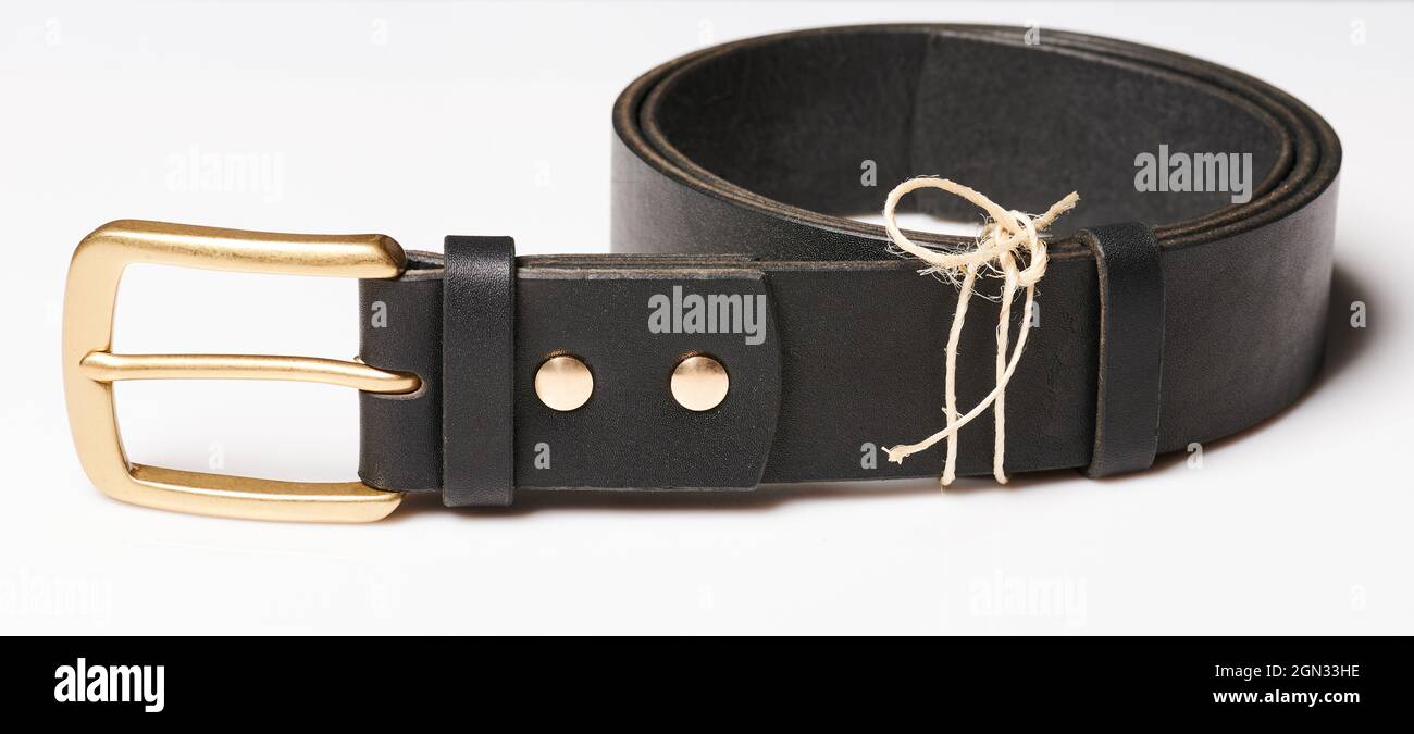 Circle black leather belt with gold color metal shiny buckle isolated