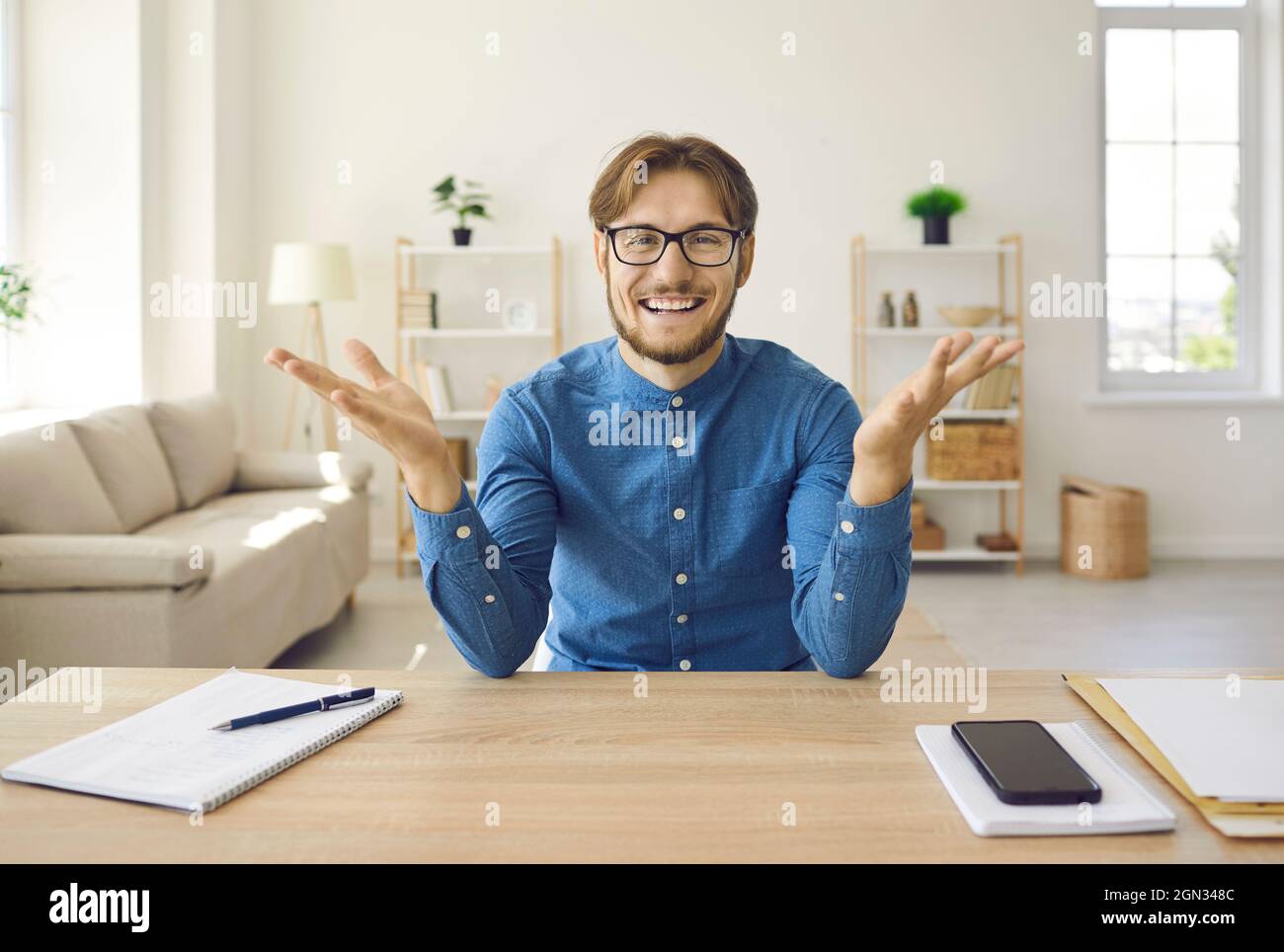Cheerful male company manager conducts online meetings with his clients using webcam. Stock Photo