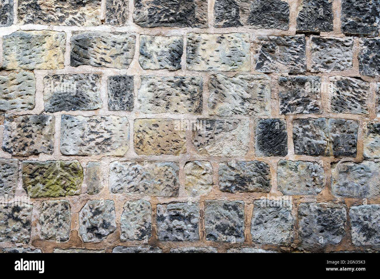 Wall background with different colored natural stones. Stock Photo