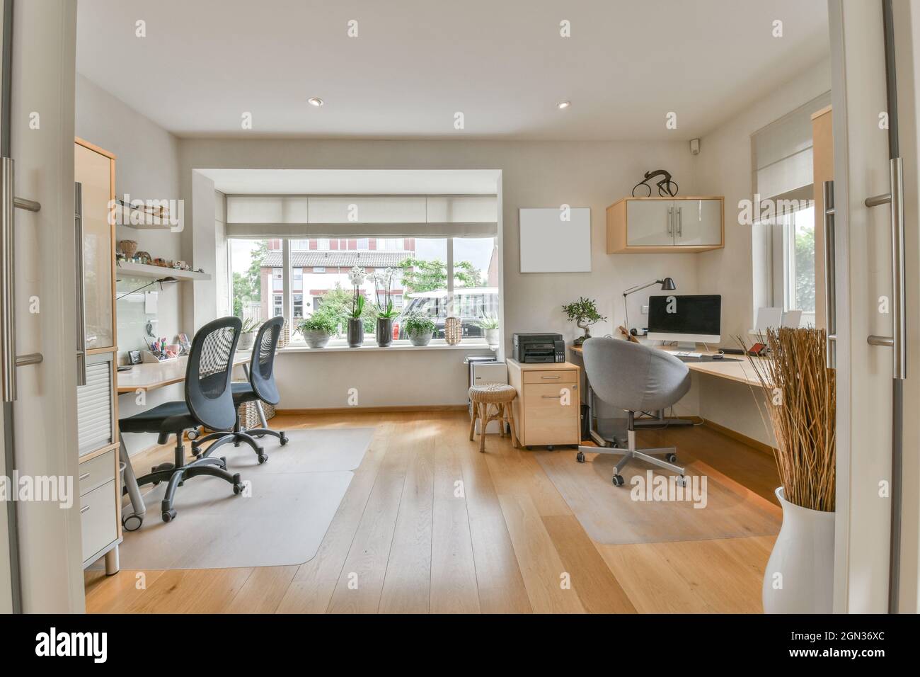 Contemporary room interior with desktop computer on table against