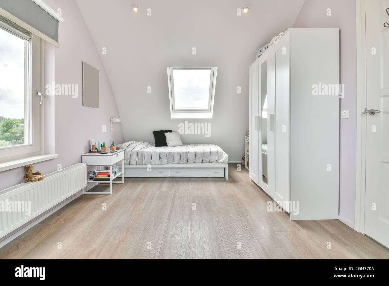 Modern bedroom interior with bed and closet against window above toy on ...