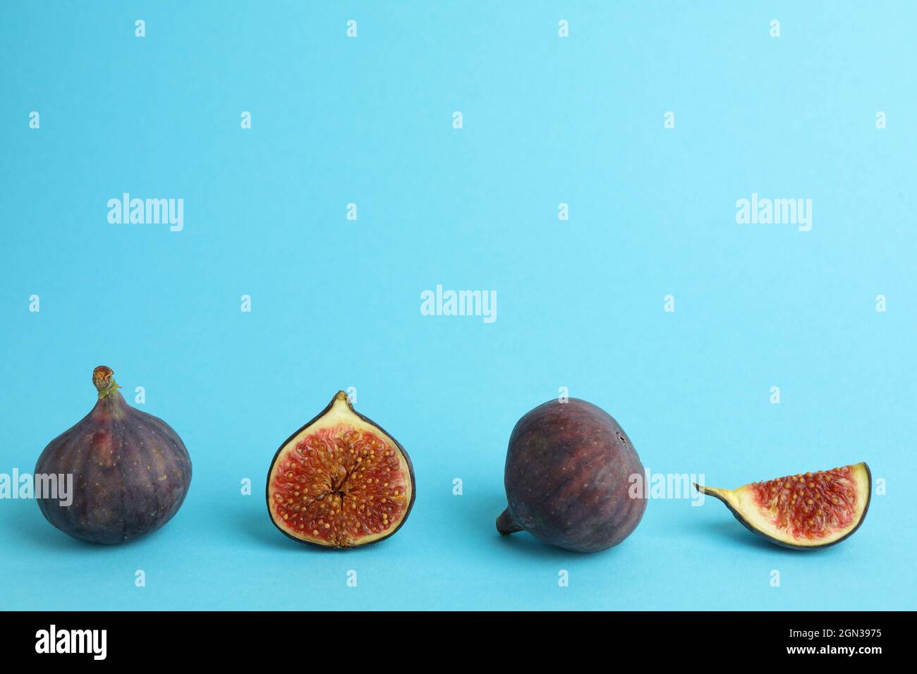 Fig on blue background, space for text Stock Photo