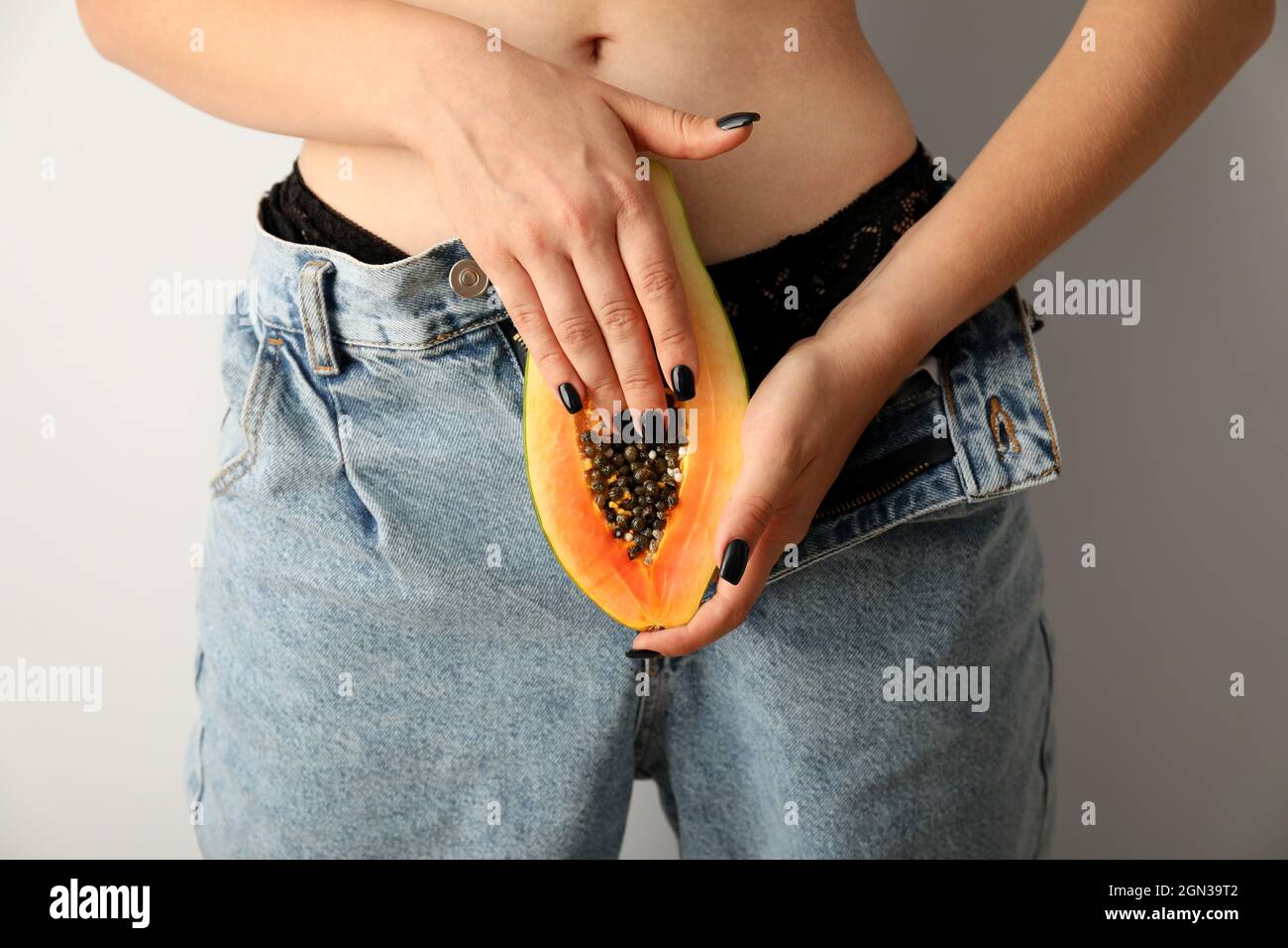 Masturbation concept with woman holding papaya, front view Stock Photo -  Alamy