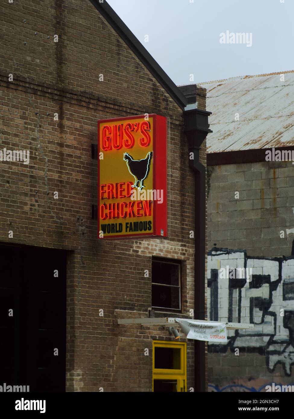 LOUISIANA, UNITED STATES - May 21, 2021: A restaurant sign of Gus’s World Famous Fried Chicken on a brick wall in New Orleans Stock Photo